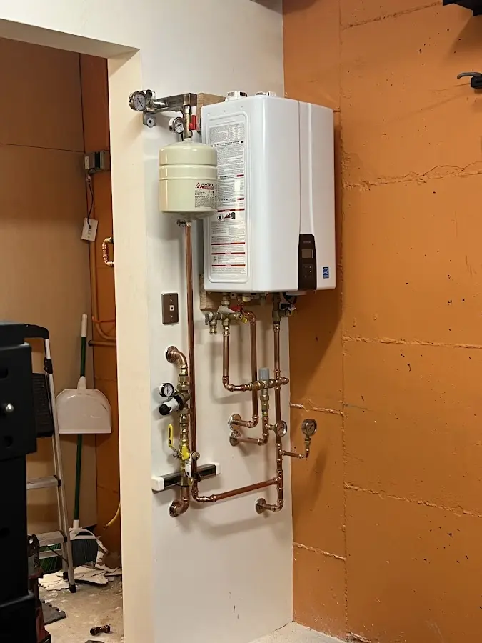 Plumbing technician inspecting water heater connections in Maricopa